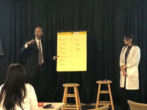 Gurpreet Dhaliwal, MD, guides residents through the process of developing a differential diagnosis for a case presented by resident Hisami Oba, MD.